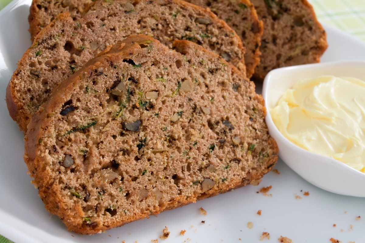 Slices of baked zucchini bread on a white plate.